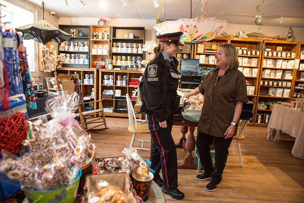 A Peterborough Police officer has a lighthearted conversation with a gift shop store clerk